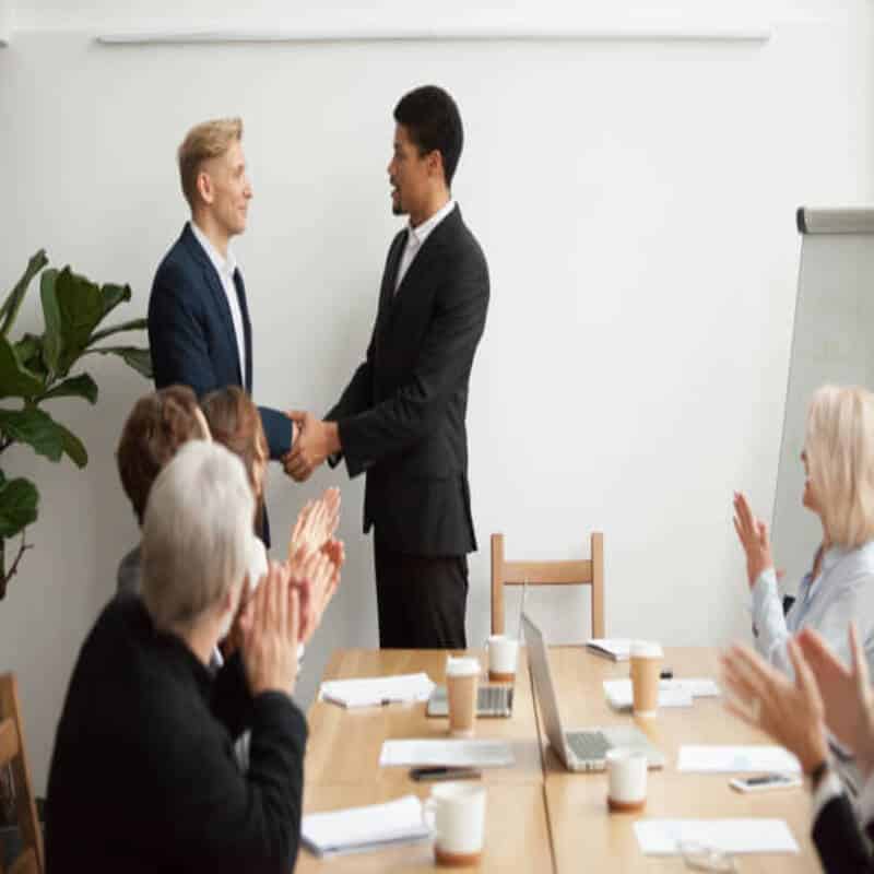 black ceo white businessman shaking hands group meeting 1163 4885 1 1
