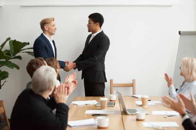 black ceo white businessman shaking hands group meeting 1163 4885 1